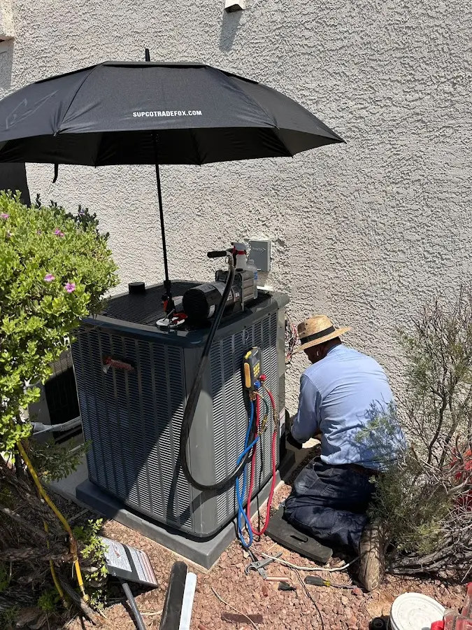 HVAC technician performing outdoor AC maintenance in Tarboro